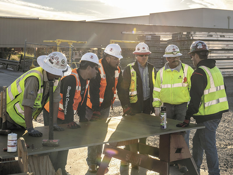 Construction workers meeting over a table